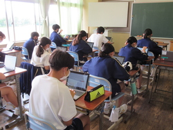 教室でタブレットで答えている写真
