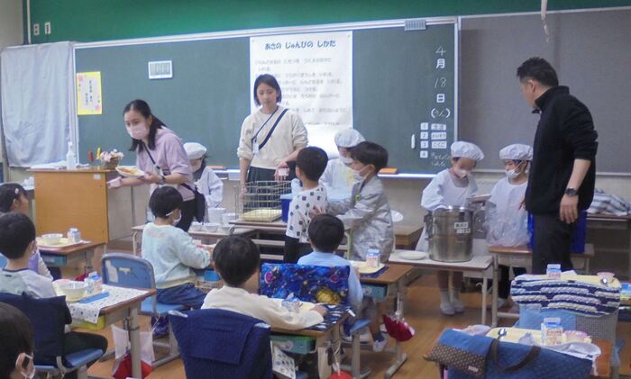 給食当番がもりつけている写真